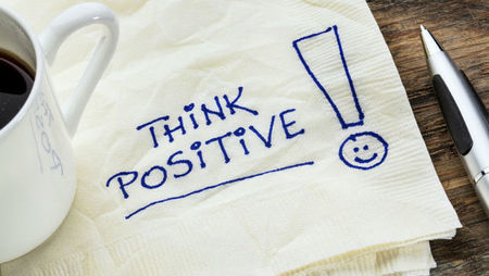Think positive text written on a tissue with pen 