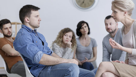 Substance abuse counsellor conducting group therapy session