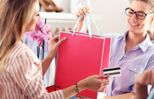 Female customer paying female shop assistant