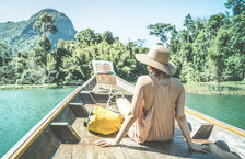 Woman with her back to the camera enjoying a boat trip