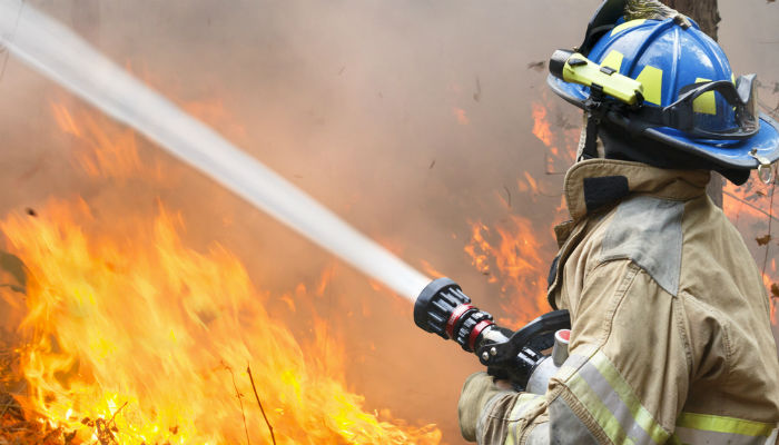 Firefighter battling a wildfire