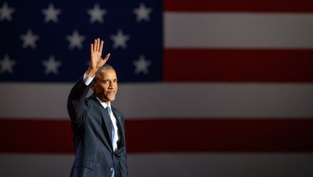 Former US president Barack Obama waving at a crowd
