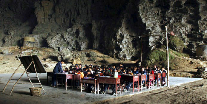 Dongzhong Elementary Cave school - students sitting at their desks in a cave facing a blackboard