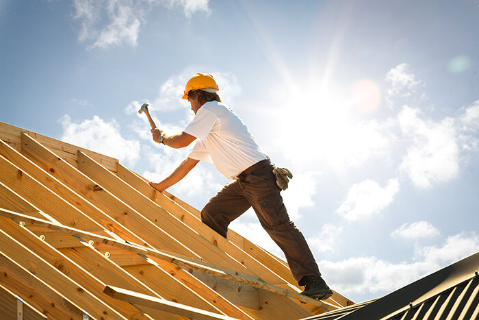 A roofer fixing a roof.