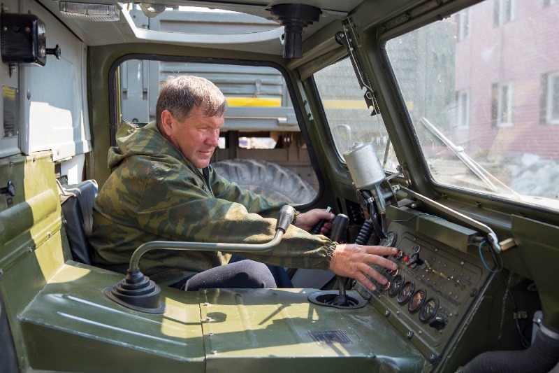 Military driver sitting in an army vehicle