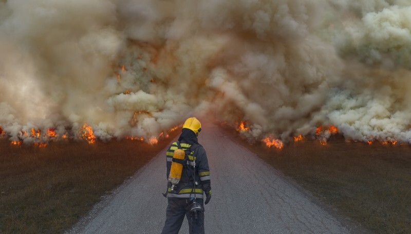 Firefighter looking at difficult fire